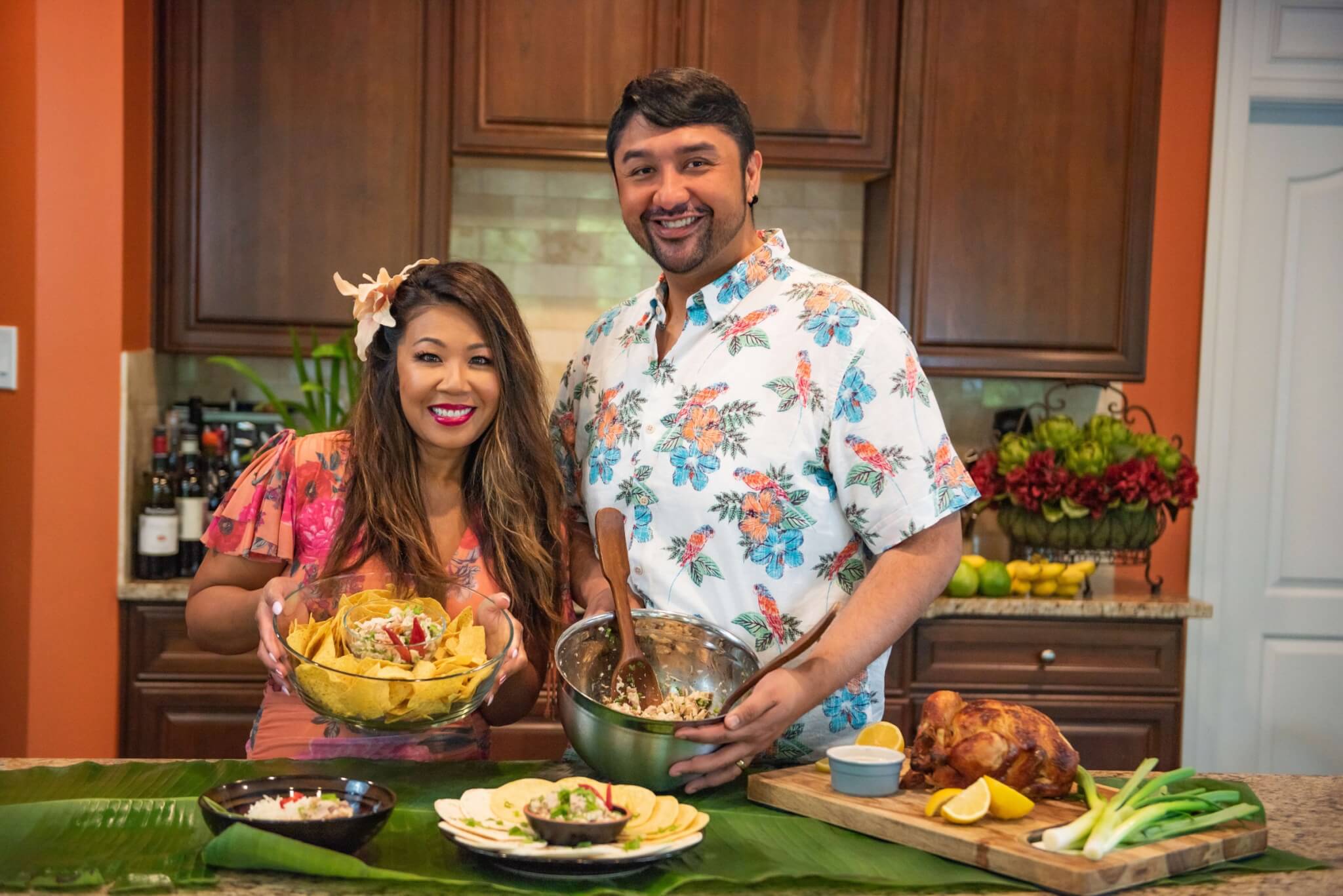 Cynthia of Predupre and Craig Manalo-Cabrera smiling at camera holding the Chicken Kelaguen dish