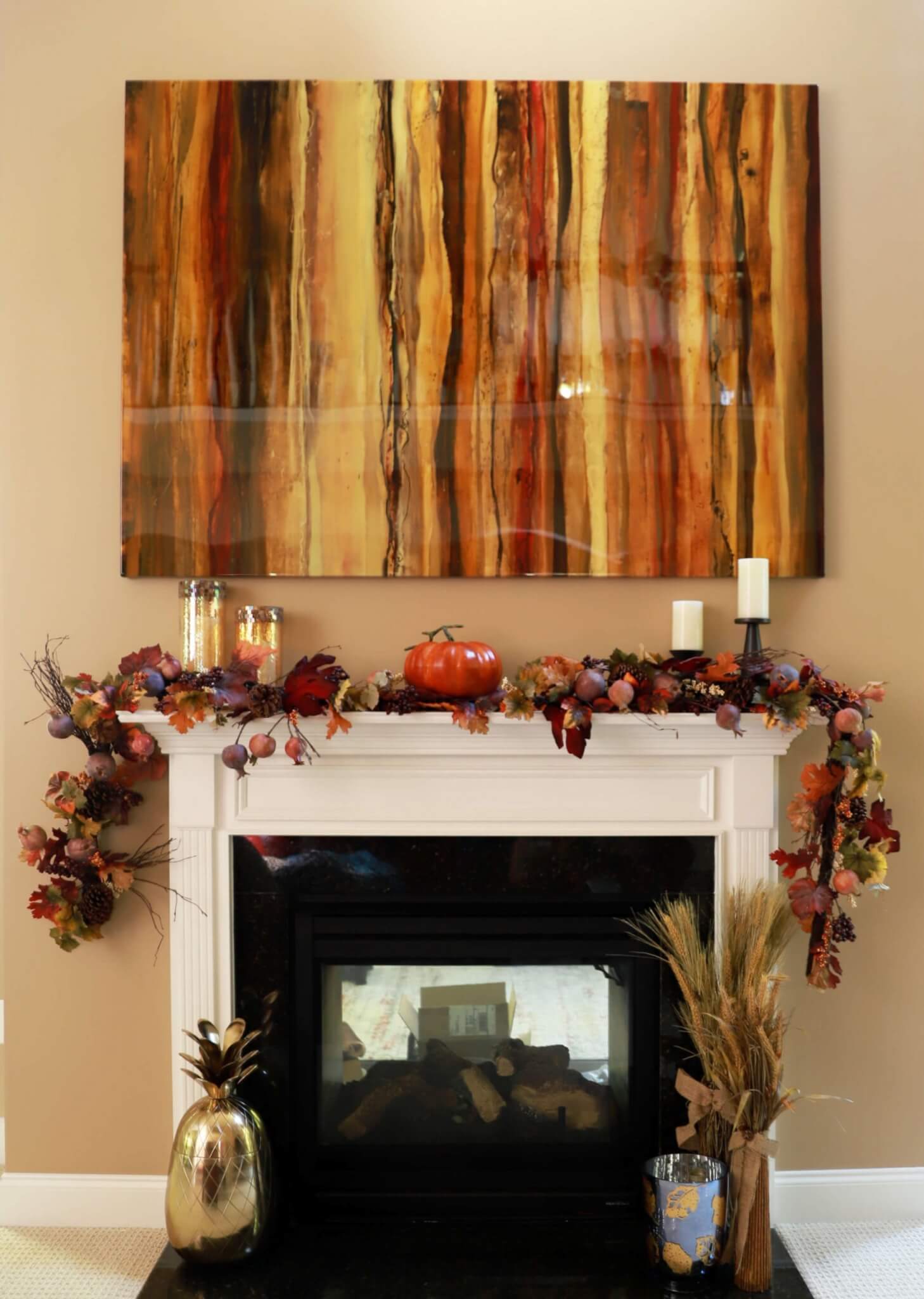 mantel decorated with fall leaves and pumpkins