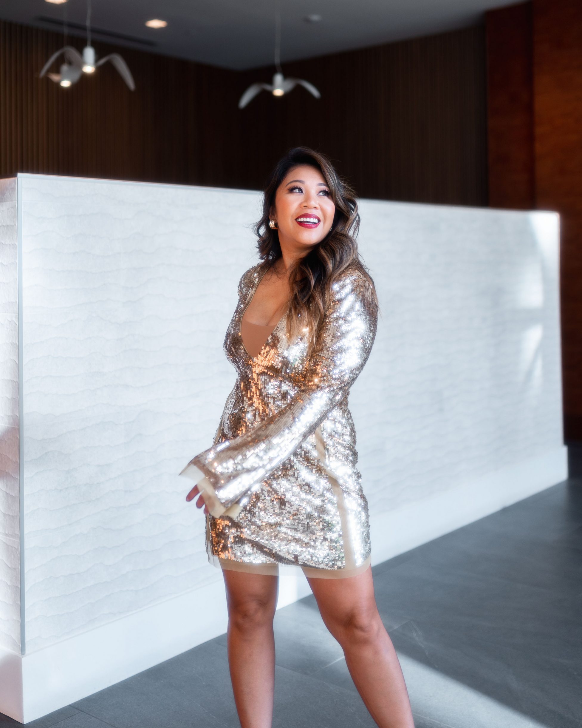lady swaying in her gold sequins dress.