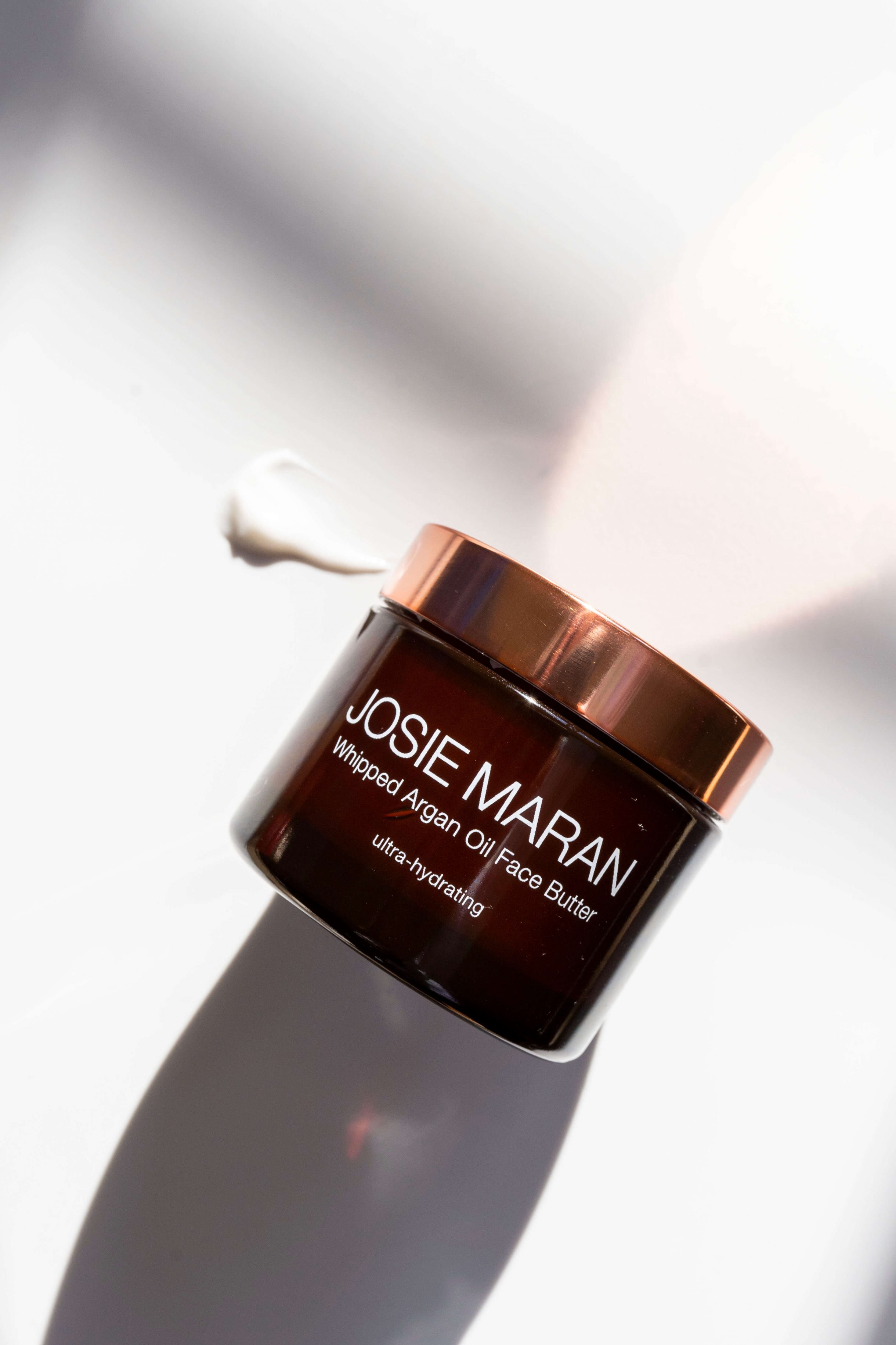 showing a bottle of Josie Maran Whipped Argan Oil Face Butter