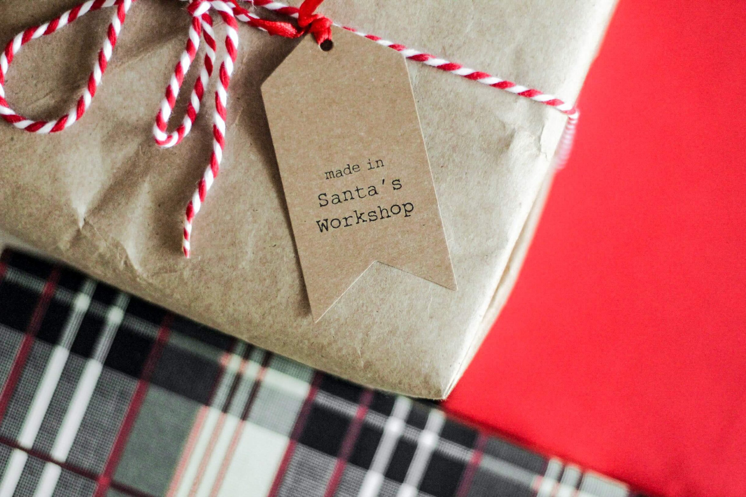 gift wrap with red and white ribbon and a gift tag that says made in Santa's Workshop