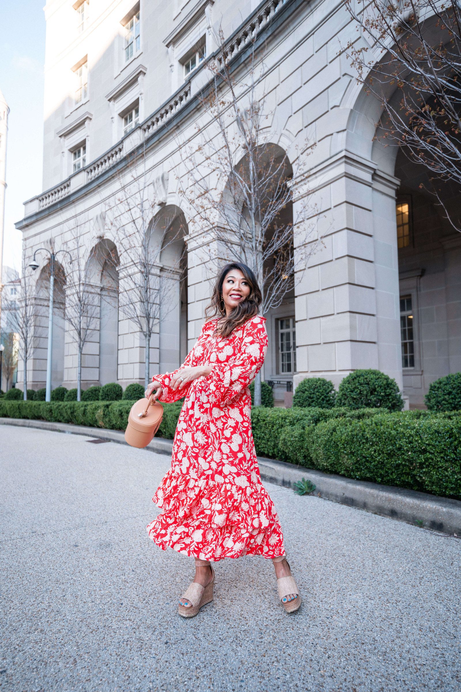 Predupre wearing a floral maxi dress with wedges